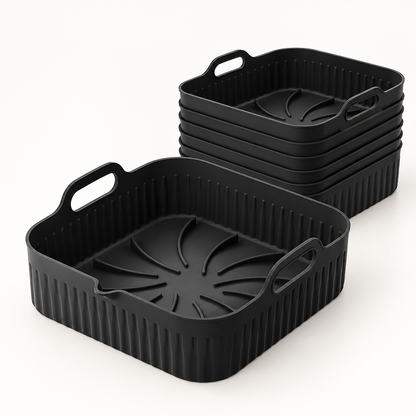 Pack de 6 bandejas de silicona negras Manacor para freidora de aire, de 26 por 25 cm, sobre una superficie clara