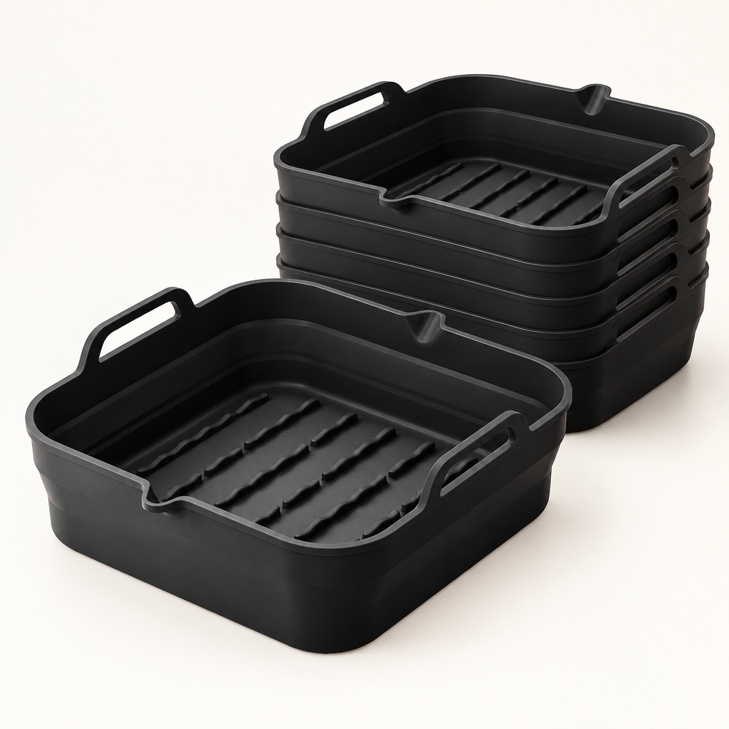 Pack de 6 bandejas cuadradas de silicona negras Manacor para freidora de aire, de 8,5 por 27 por 24 cm, sobre una superficie clara