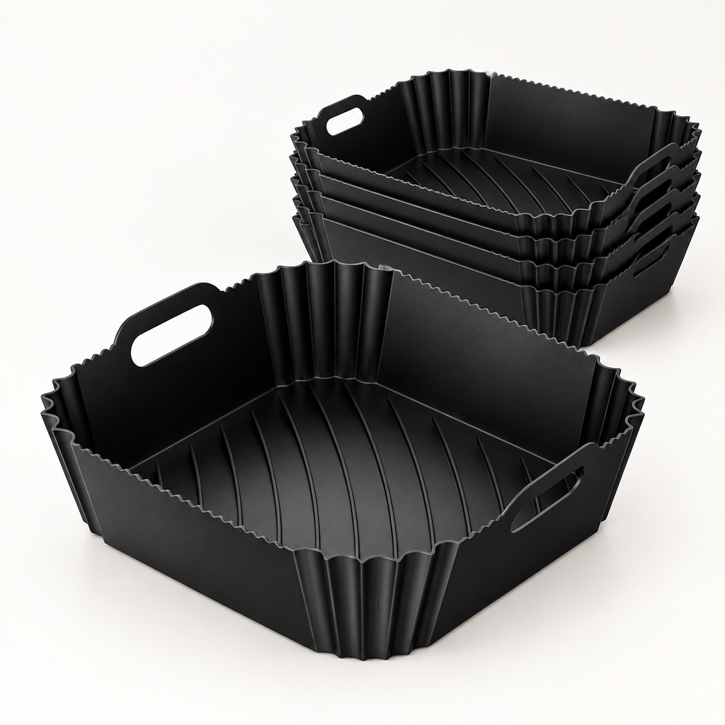 Pack de 6 bandejas de silicona negras Manacor para freidora de aire, de 6 por 22,5 por 22 cm, sobre una superficie clara