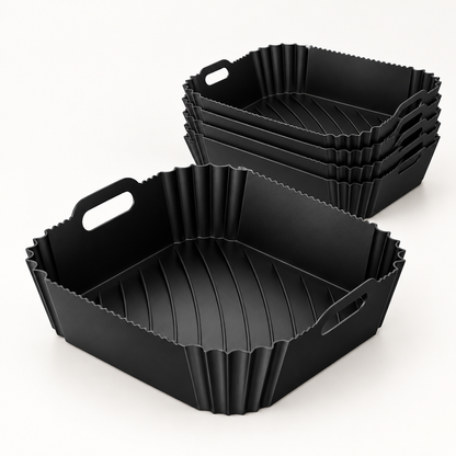 Pack de 6 bandejas de silicona negras Manacor para freidora de aire, de 6 por 22,5 por 22 cm, sobre una superficie clara